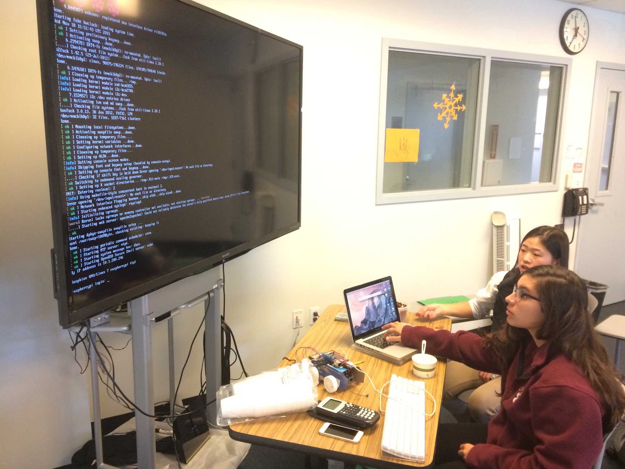 Sophomores Halie Kim and Carlota Rubio analyze code developed for their self made cars.