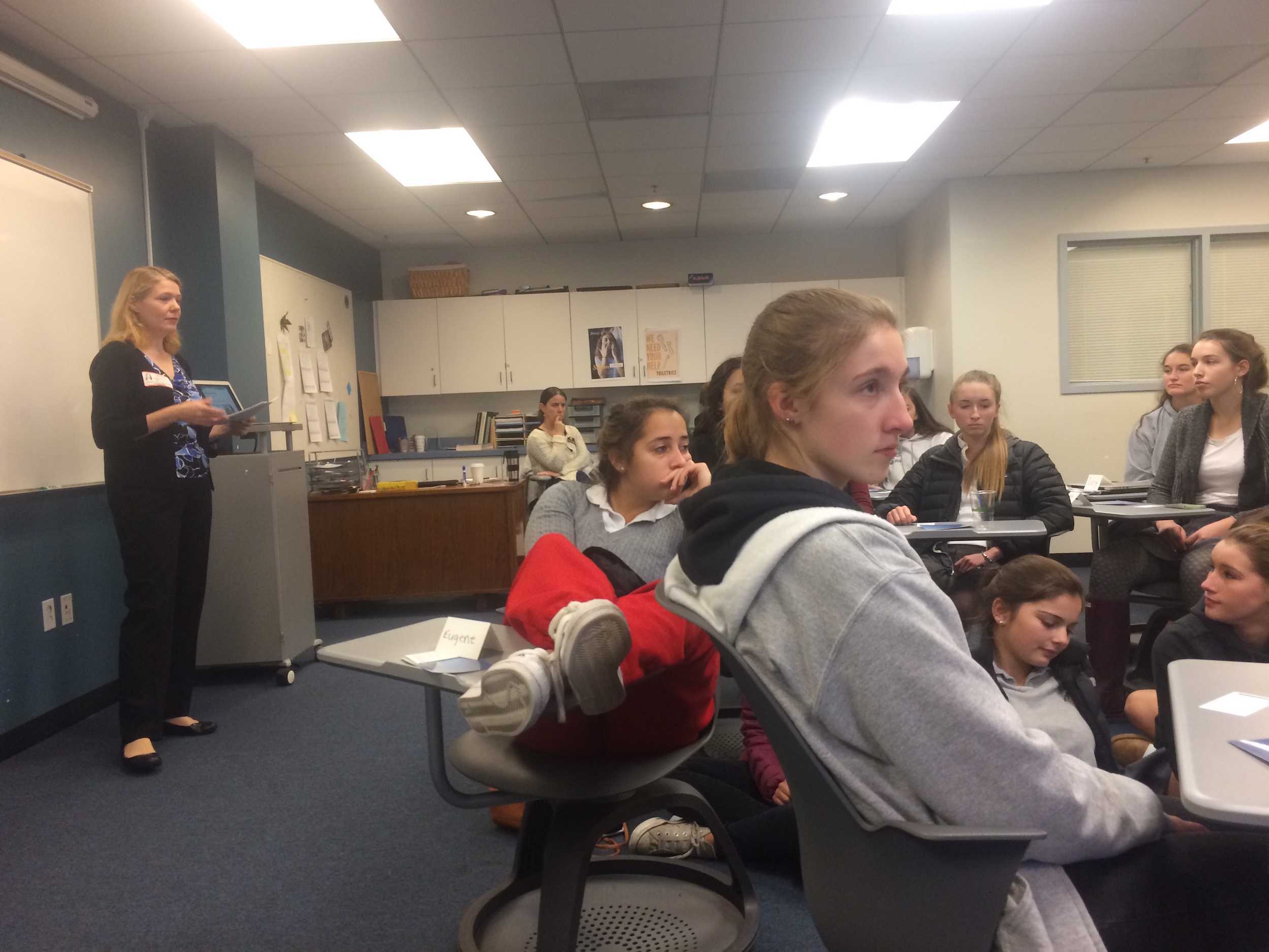 Attendees listen to Dummel as they view her presentation listing stress reduction methods. Juniors and seniors also did breathing exercises and meditation in order to bring the stress reduction process to life.