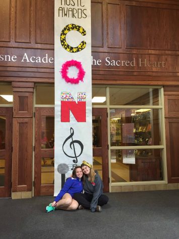 Sophomore Katie Walsh and senior Grace Neary from the Duchesne Academy of the Sacred Heart in Omaha, Nebraska announce Congé. The student body engaged in a musically-themed holiday.