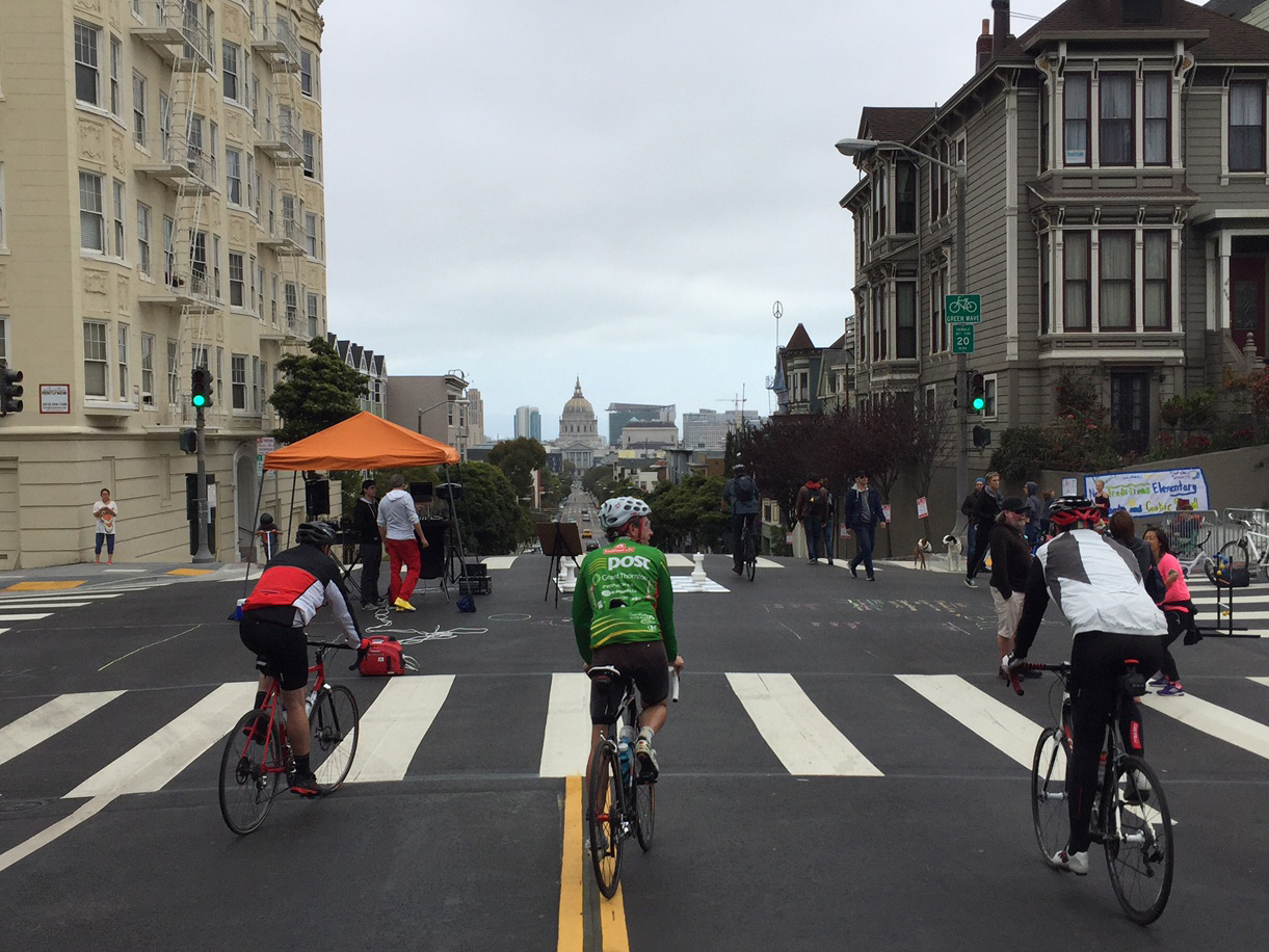 Three bikers ride down Fulton Street, a car-free area of the Western Addition Sunday Streets. The concept of closing streets to vehicles to create outdoor neighborhood markets started in Bogotá, Columbia and has spread to cities spanning around the globe.