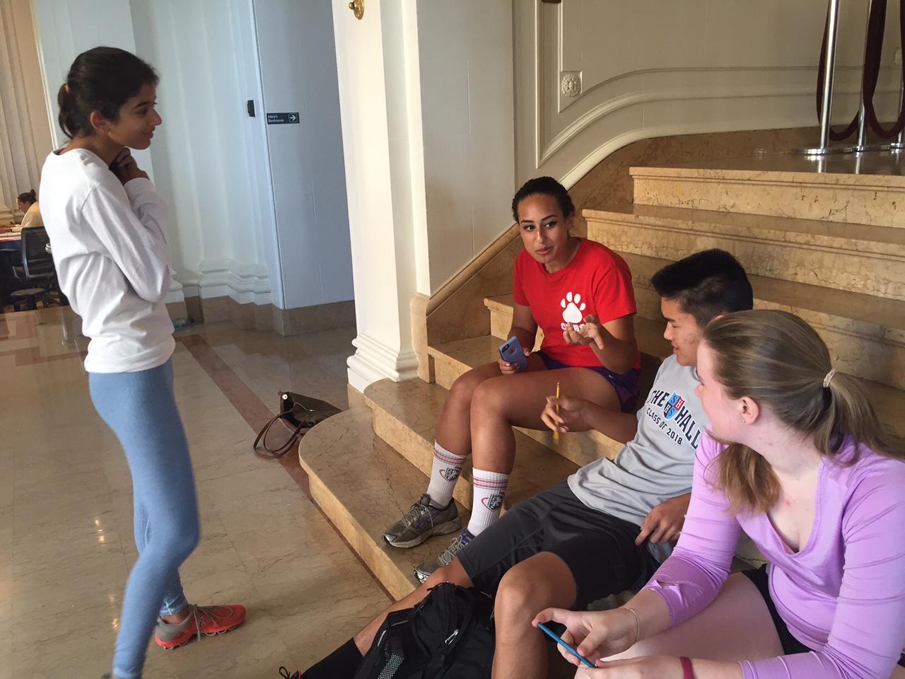 Cross-country runners wear Convent and Stuart Hall themed shirts while waiting for practice to start. Today's theme for Spirit Week was Convent and Stuart Hall.