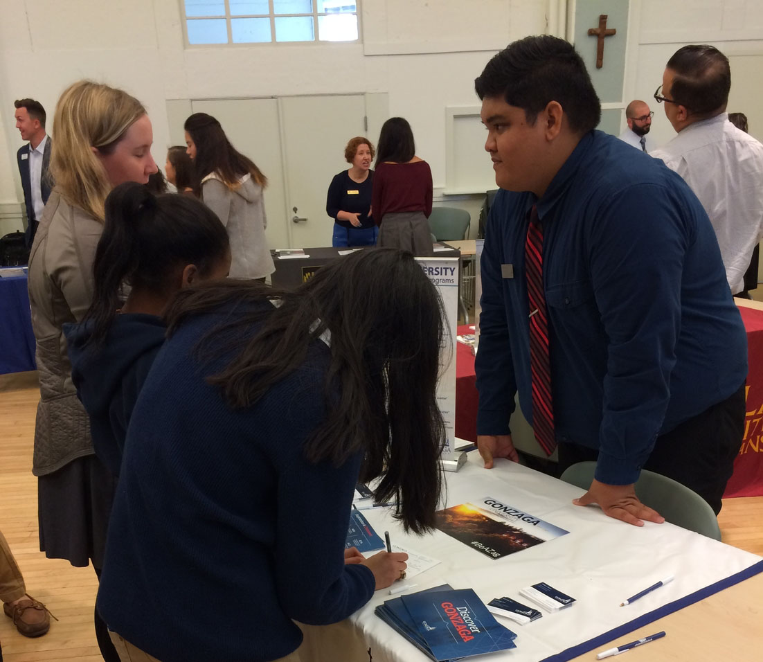 Seniors speak with an admissions representative from Gonzaga University in Spokane, Washington. The Jesuit Excellence Tour provided an opportunity for students to ask personal questions, fill out information cards, and pick up brochures and handouts from 20 schools.