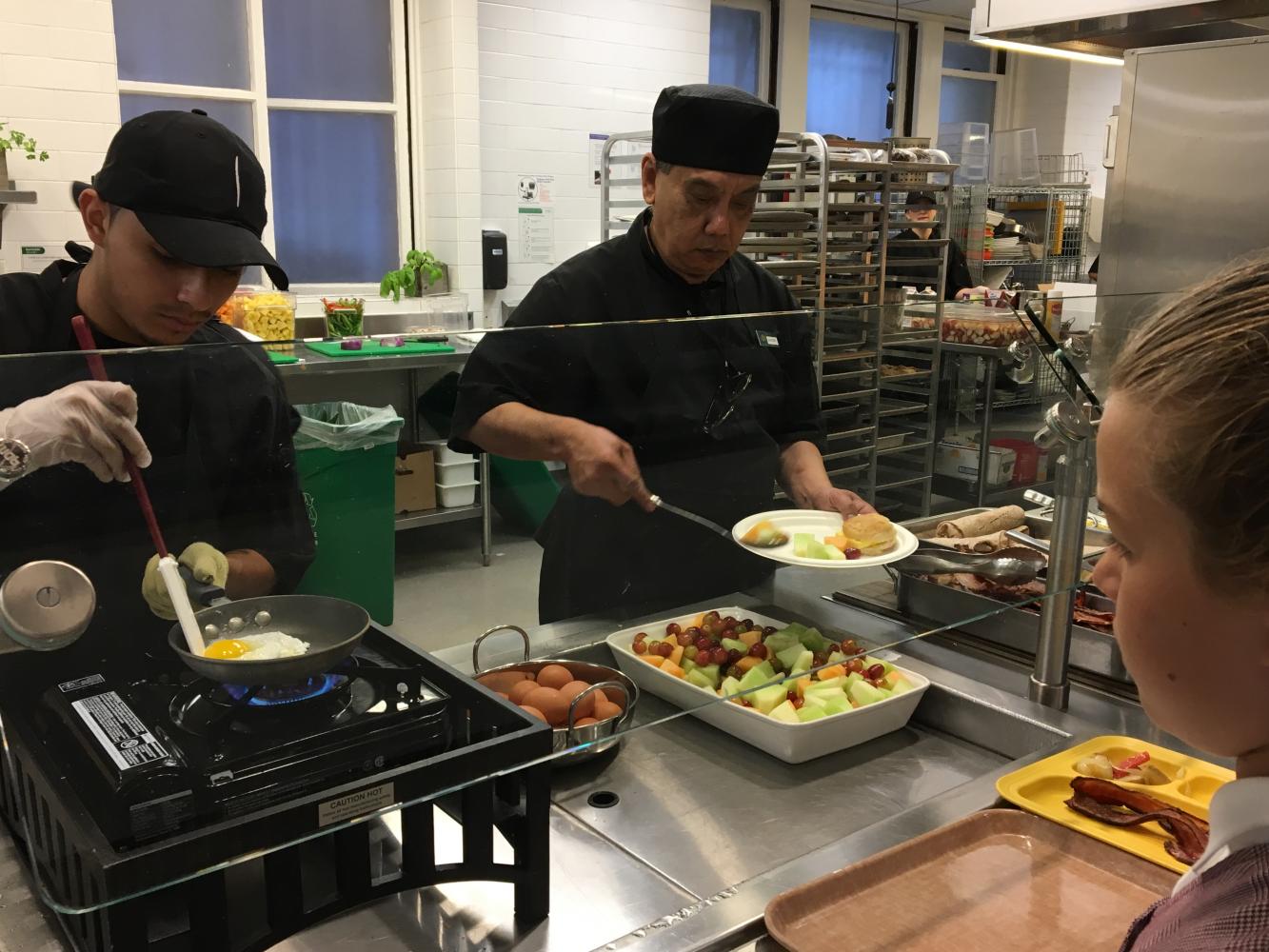 A Convent Elementary student waits for her sunny-side up eggs to be made during the cafeteria's new breakfast service. Students and faculty can order and buy a variety of breakfast options before the school day starts.