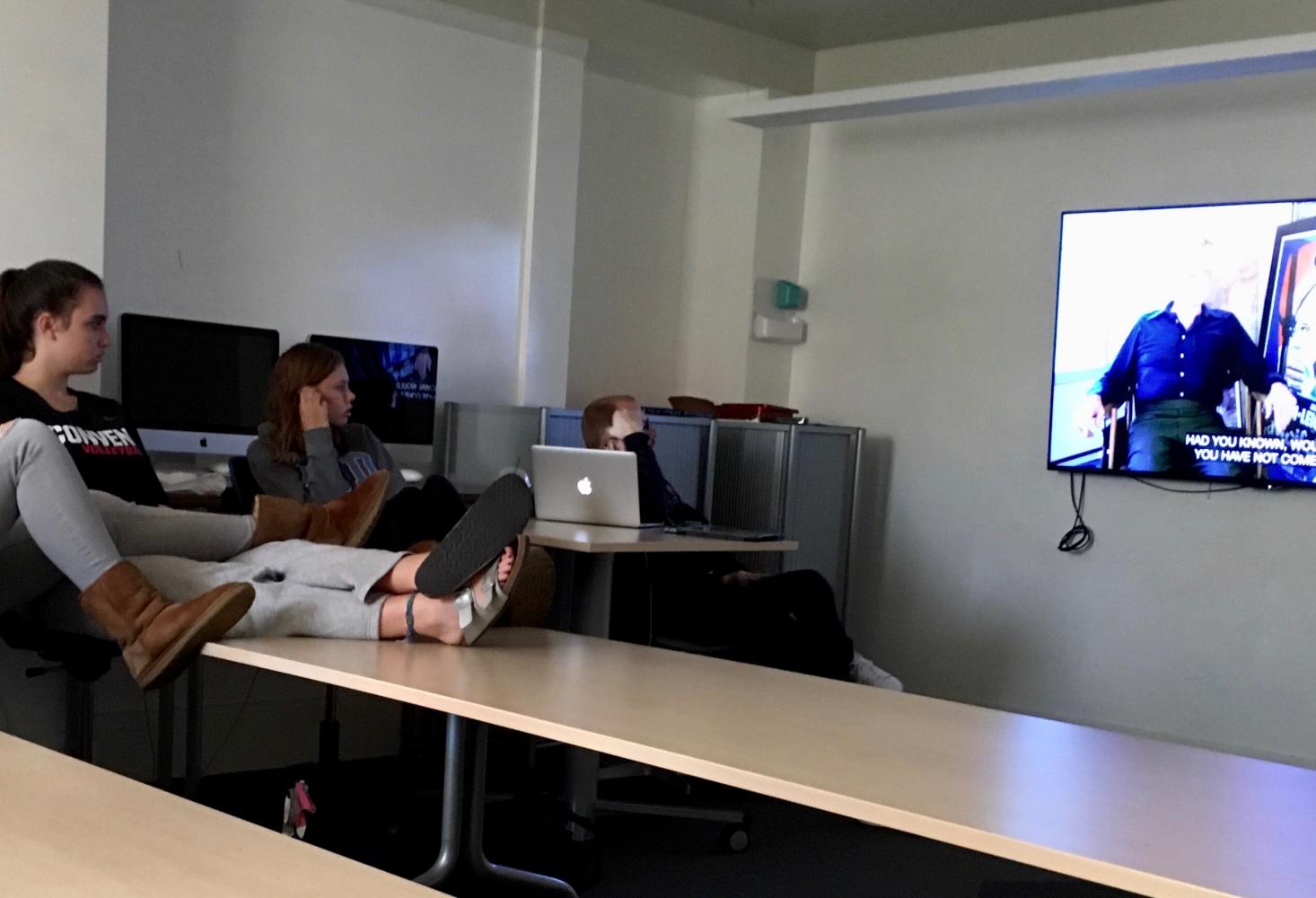 Juniors Amelia Estes and Molly Brown watch an interview between Charlton Heston and Michael Moore in “Bowling for Columbine.” Heston was the president of the National Rifle Association from 1998-2003.