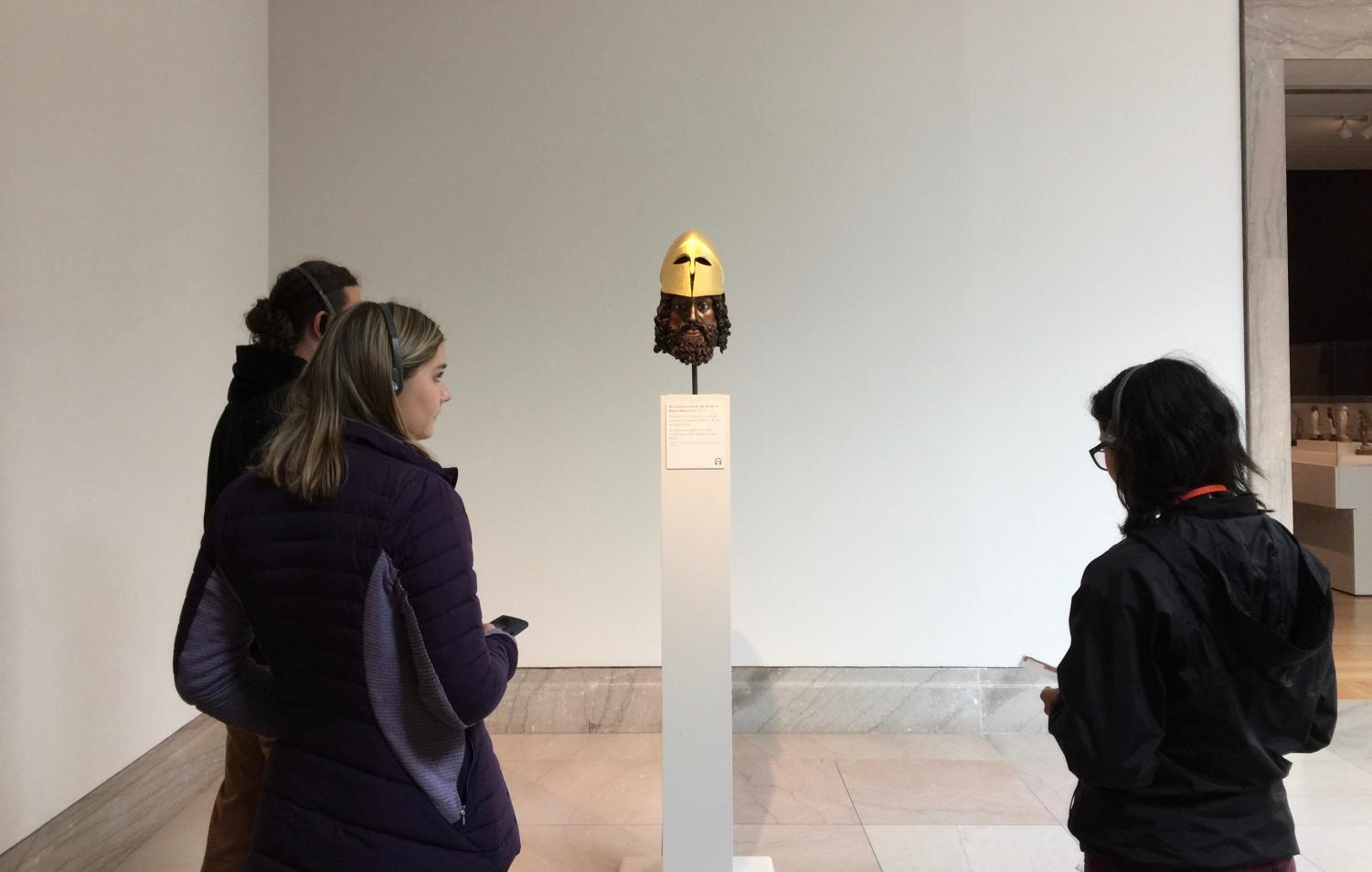 Sophomore Brooke Wilson listens to head set and looks at a replicated ancient sculpture during the Latin III Honors visit to the Legion of Honor Museum. Students had learned about polychromy and the science behind the colors prior to the trip.