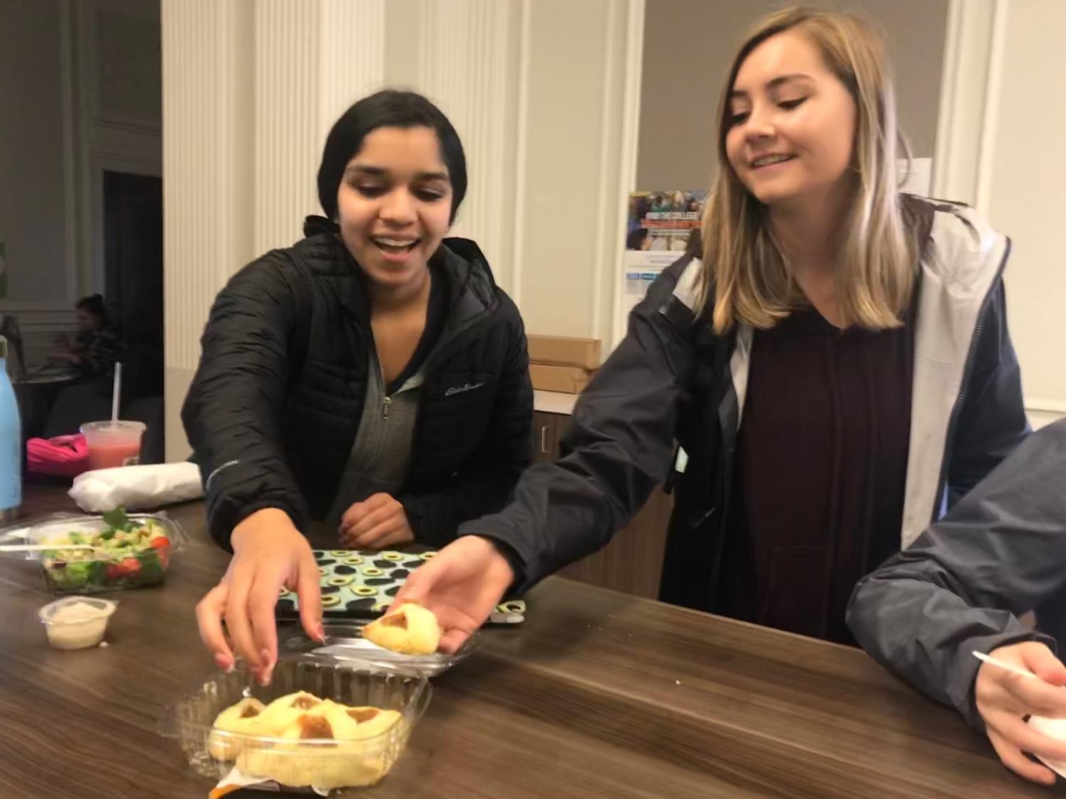 Sophomores Avani Mankani and Brooke Wilson eat hamentashens in the center during lunch to celebrate the Jewish holiday Purim. Hamentashens are traditional triangle shaped cookies eaten primarily during Purim.