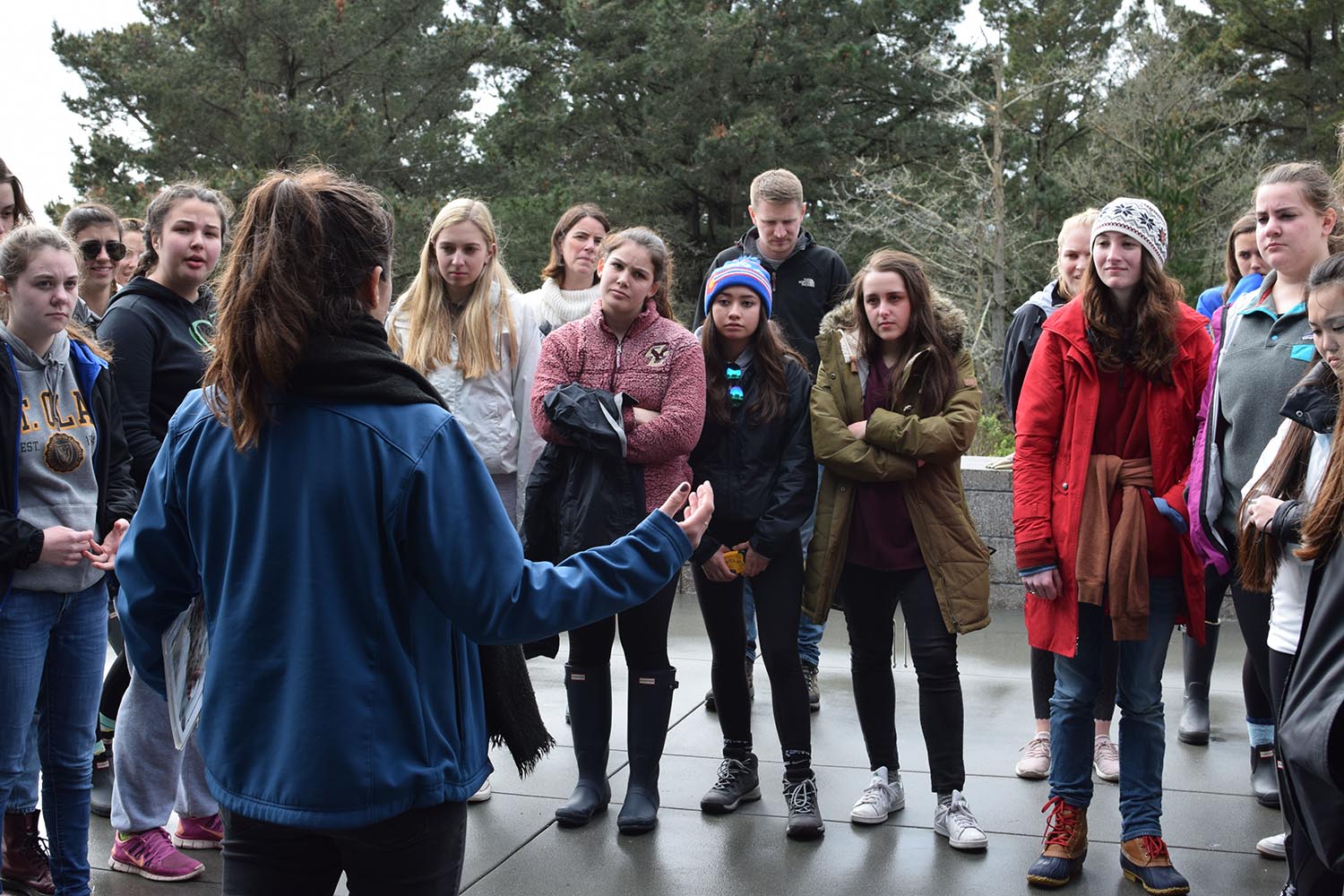 Seniors on retreat listen to an introduction about the Marine Mammal Center in Sausalito before going to observe the animals. The class stayed up past 11 p.m. for a circle sharing activity later that night.