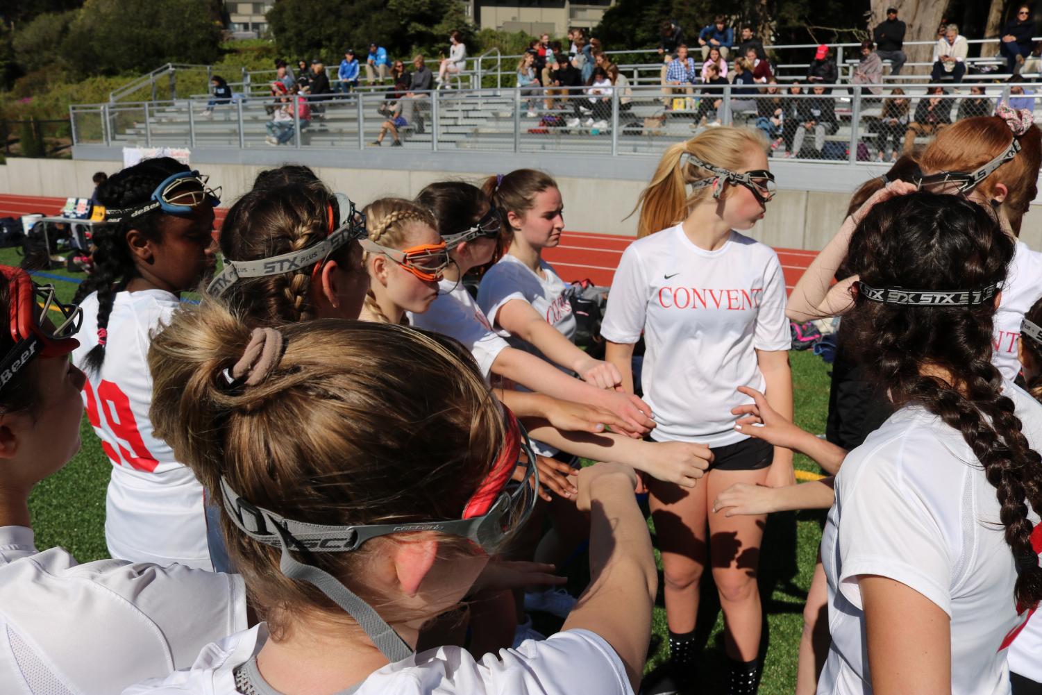 The lacrosse team huddled up before the first half of the game. Convent won against Bay High School with a final score of 11-9.