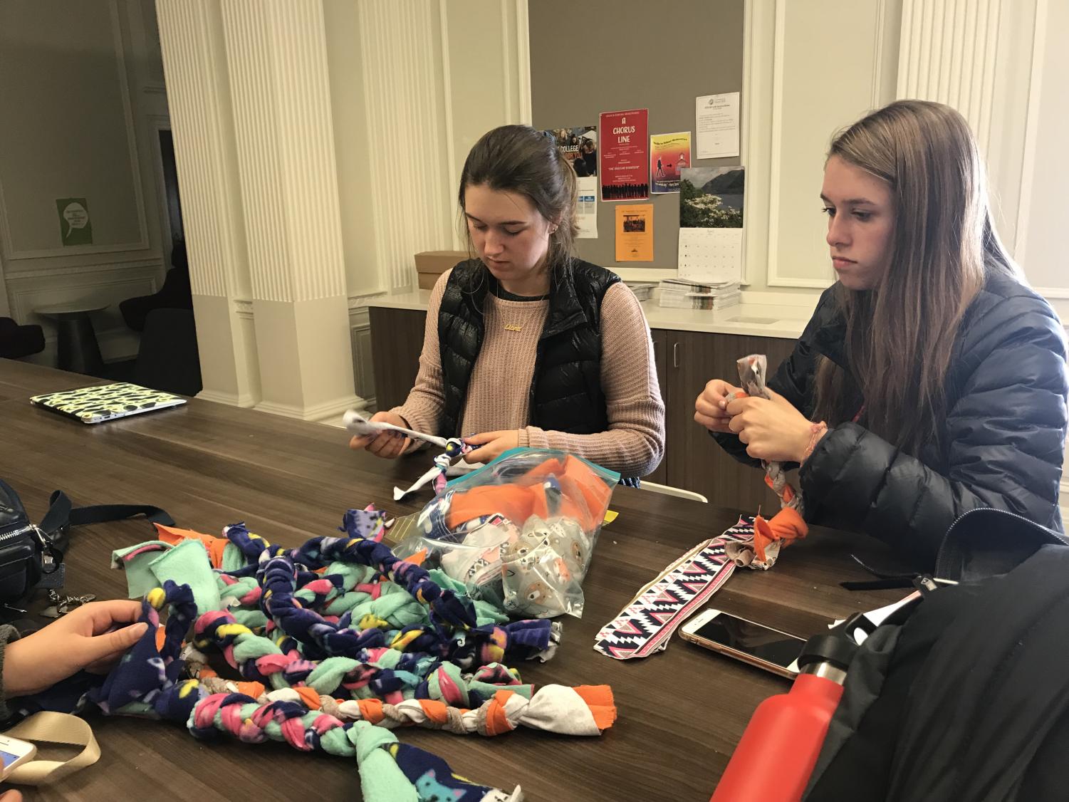 Sophomores Ella Beard and Peyton House create toys for cats and dogs by weaving pieces of fabrics tightly together. All 27 toys produced today will be donated to the Marin Humane Society shelter for pets.