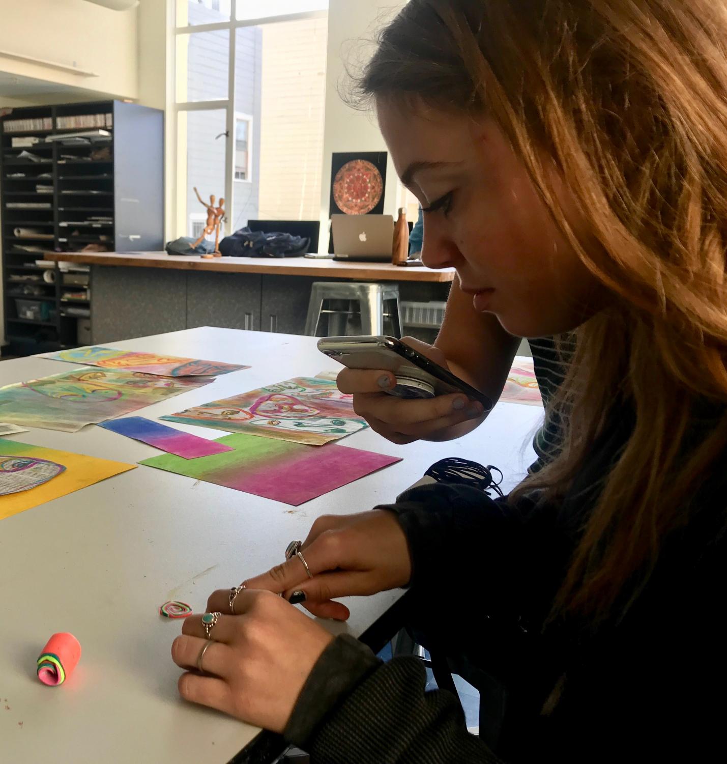 Senior Elizabeth Worthington cuts clay in preparation for her final project. Students will display their work at the end of the year in an art show.