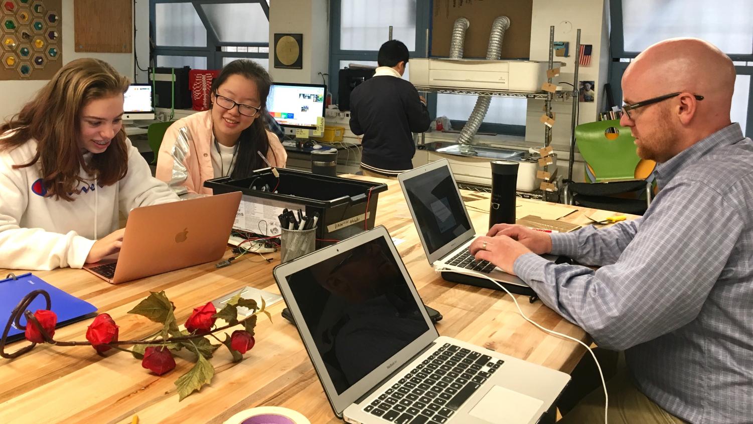Club head Zoe Hinks and junior Michelle Wang discuss plans for the Innobotics Club with the club moderator during a lunch meeting in the Unkefer Spark Studio. The Clubs Assembly will be held on Monday.