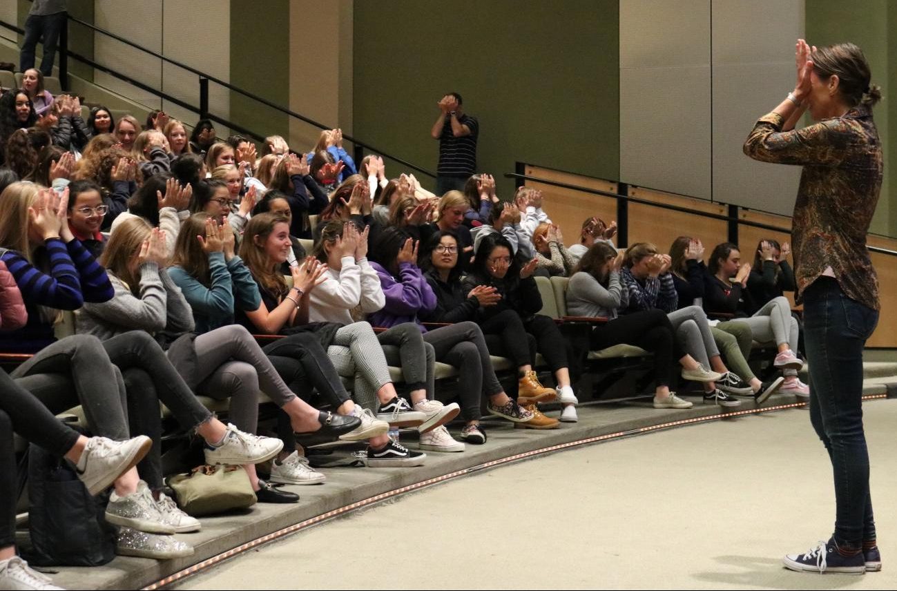 Academic Support Coordinator Jennifer Kramer leads students in an exercise to reduce stress. Kramer and Annie Egan, K-12 Director of Student Support, presented on mental and physical wellness and offered multiple tactics to control anxiety.