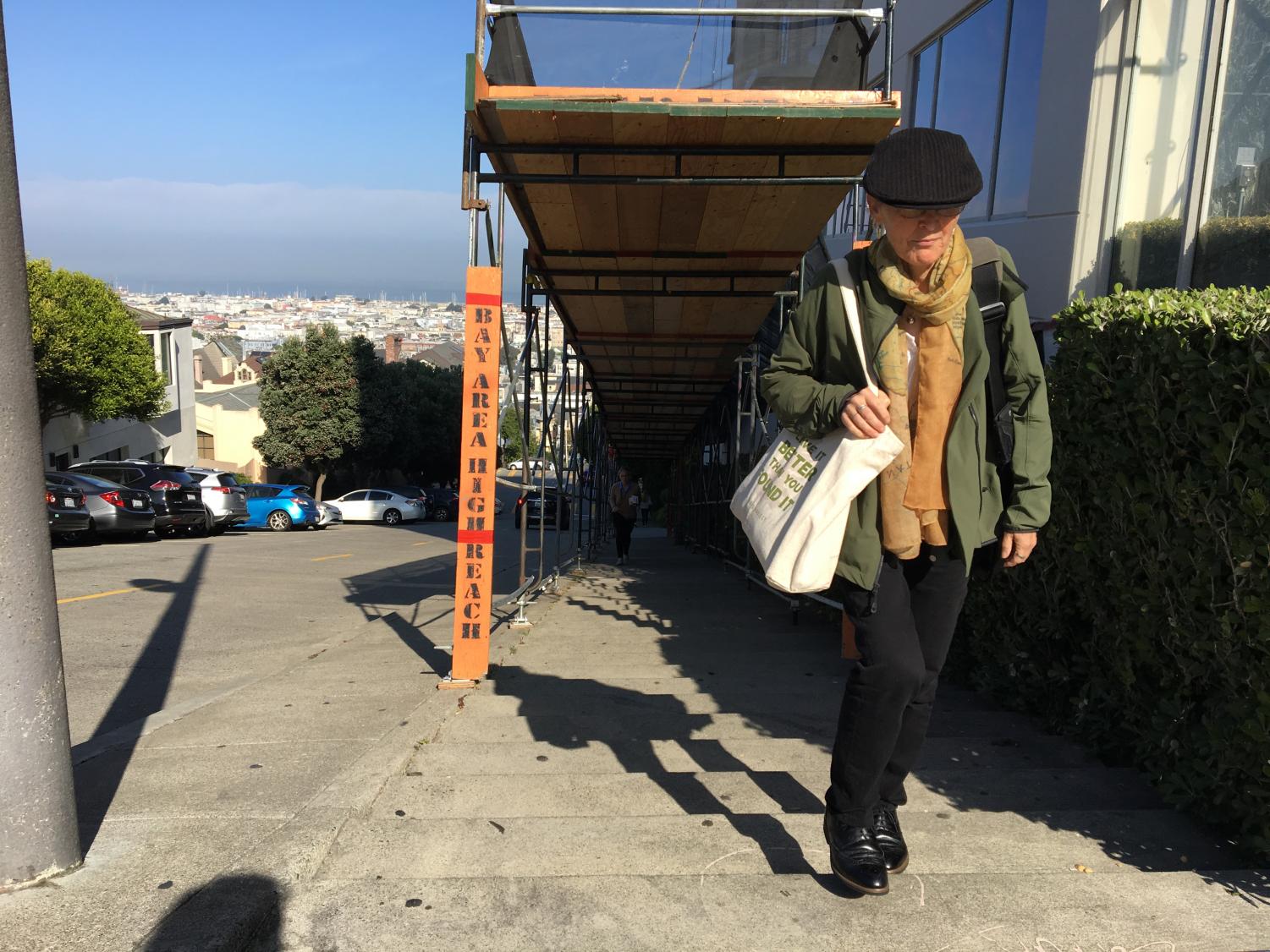 TRIP'S END Theology teacher Kate McMichael walk up the Fillmore Street hill as part of her daily trip to school from her home in Fairfax. McMichael spends up to three hours commuting each day.