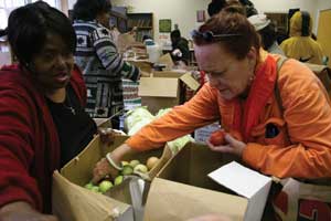 Volunteers Doris Greene and Pamela Newman help package food. The San Francisco Food Bank distributes food to over 600 Bay Area community programs. 