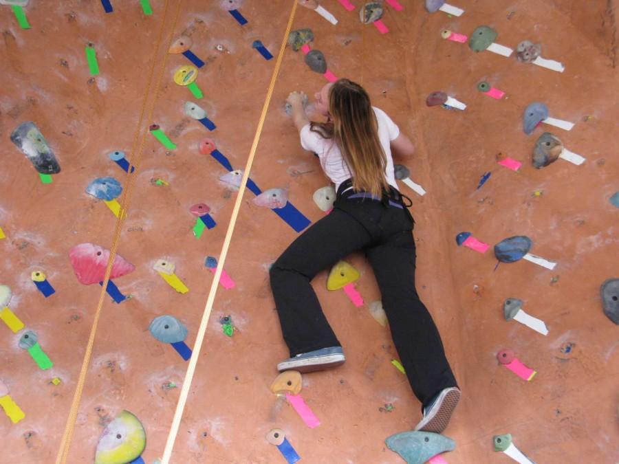 Sophomore Caroline Welsh climbs a rock-climbing wall at the Berkeley Ironworks Climbing & Fitness Center for her sophomore retreat. Athletic director Elena De Santis encouraged her from the ground to continue climbing.