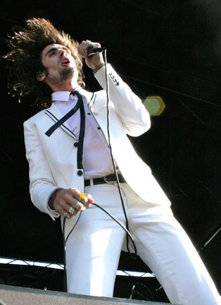 Tyson Ritter, lead singer in The All-American Rejects flips his hair up while performing for the large crowd at Warped Tour. The band has toured with many established bands such as Rooney and Fall Out Boy.