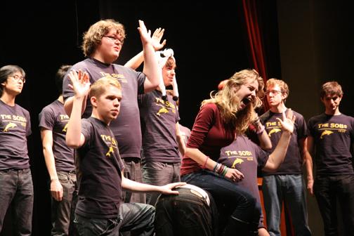 Senior Lauren Arnold laughs as she sits on her throne of SOB members. Arnold played games on stage with the group before she was serenaded. 