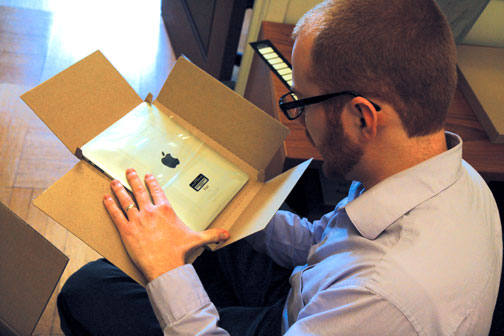 Theology teacher Paul Pryor-Lorentz places an inventory label on an iPad for use by a faculty member. Teachers involved in the program received their iPads last Thursday and will begin curriculum development immediately.