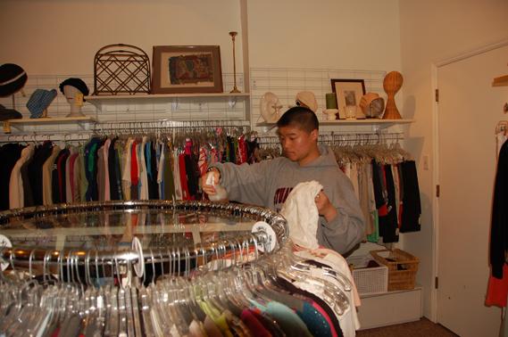 Anjali Shrestha | the broadview. Freshman Patrick Wong sorts clothes at Seconds to Go as a volunteer. CSH and SHHS students can get community service hours working at the store located on Filmore St. 