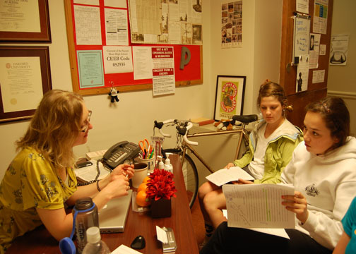 Katy Hallowell | the broadview.  Juniors Taylor Carlson and Solana Boboschi sit in Kievlan's office and discuss grades they recieved on an english paper. Kievlan tutors students in all subjects, and helps them to build effective study habits.