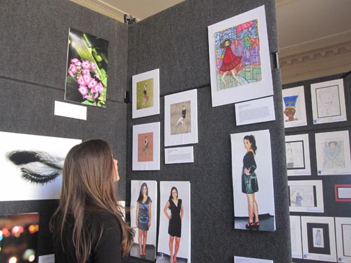 Freshman Margaux Gaede checks out art by Convent seniors displayeed in the Four School art show. The annual show appears in the Main Hall for over a week. Anjali Shrestha | the broadview.