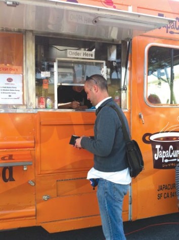 A customer at Fort Mason’s weekly Off the Grid market pays for his order at JapaCurry, a food truck offering Japanese style curry rice. Over 30 trucks and tents are available at Fort Mason every Friday from 5 p.m.–10 p.m. KATY HALLOWELL | the broadview