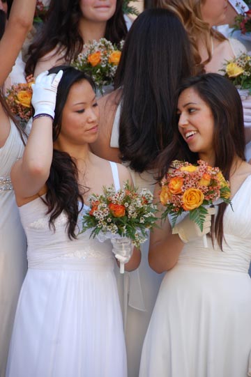 Seniors Lindsey Eng and Monica Rodriguez fix their hair before the offical class of 2011 portrait will be hung in the center.  Sophia Redfern | the broadview