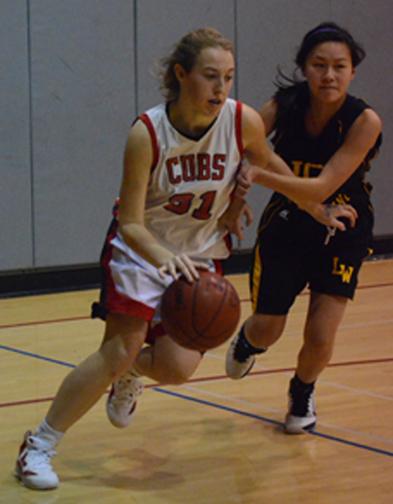 Senior Caroline Welsh drives on a Lick-Wilmerding player during the Cubs 50–39 victory. The Cubs remain undefeated and on top the Bay Counties League West. SOPHIA REDFERN | The Broadview