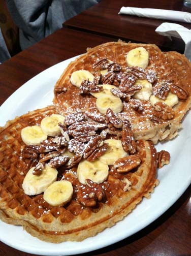Gussie’s original waffles come topped with chopped pecans, fresh sliced bananas and powdered sugar. ALICE JONES | The Broadview