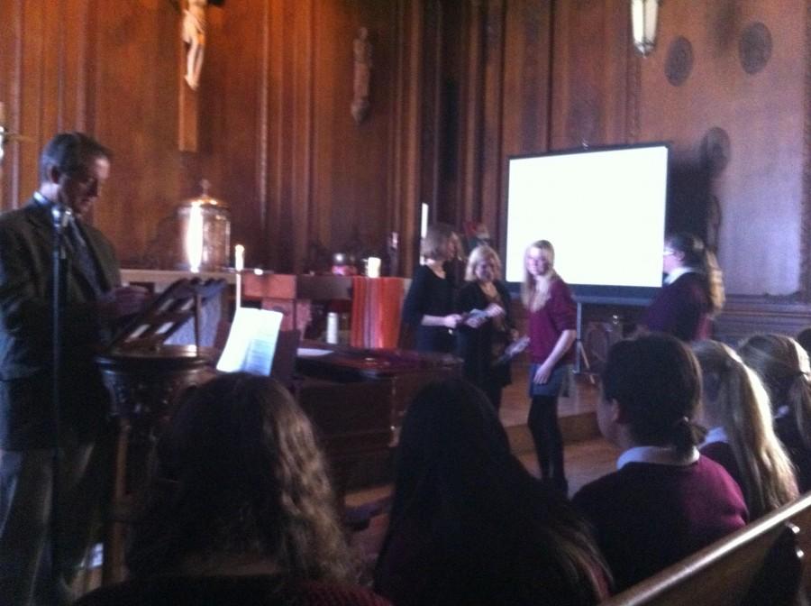 Students receive their awards from dean Rachel Simpson and interim head of school Mary Forsyth as curriculum coordinator Doug Grant reads the students names and citations during the Honors Assembly. 