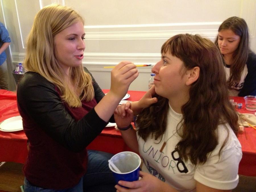 Miranda Lis paints Gaby Messinos face during the back-to-school-carnival last night. The evening included dancing, a bouncy house and root beer floats. | Photo: Ashley Latham