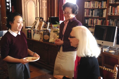 Sophomore Liana Lum, all-school winner of the Kate Chopin writing contest, talks with English teacher Julia Arce and head judge Constance Solari during a reception in the library.