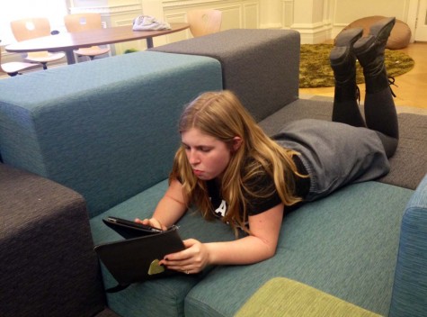Sophomore Miranda Lis works on her iPad in the Center during midterms. All iOS devices must be updated by Monday morning they will denied a connection with the schools wifi network. 