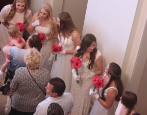 Seniors holding fuchsia gerberas greet their guests. The Class of 2014 greeted approximately 450 guests in a receiving line during Senior Tea this afternoon.