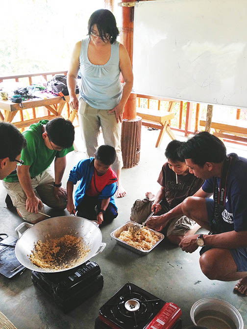 Taiwanese children make rice cereal and marshmallow treats for the first time with junior Kathryn Yu and her volunteer group. Yu traveled with Grace Covenant Church to work in schools.