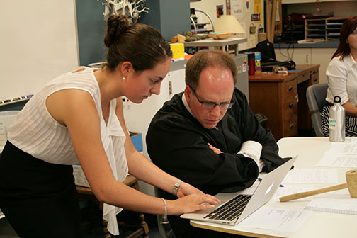 Sophomore history teacher Michael Stafford examines sophomore Bella Kearneys evidence in favor of the Europeans in the Native American versus European trial in the new sophomore Hislish class. The trial consisted of two parties with the Native American side as the prosecutors and the Europeans as the defense. Hislish is a double-period English and history class focused on oppression. The class is based off classwork and presentations with no homework or tests. 