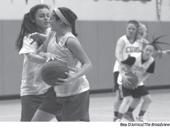 Sophomores Ally Arora and Alyssa Alvarez play a in a one-on-one scrimmage game, while seniors Maya Melrose and Jackie Wong practice their defense.