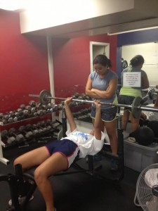 Junior Jillian Cardamon and sophomore Gia Monachino lift weights at Stuart Hall High School's weight room during a track practice.