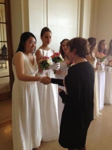 Senior Shirley Yang shakes President Ann Marie Krejcarek's hand as the final senior in the line of the 48 members of the graduating class. 