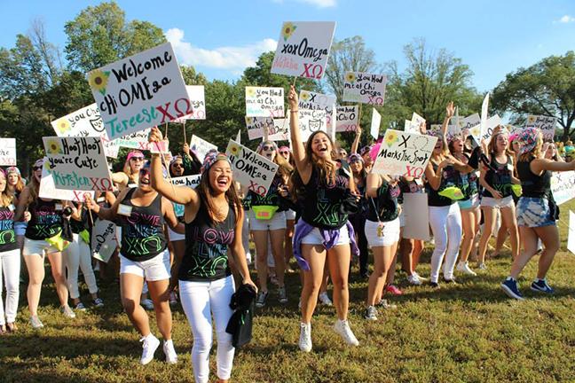  Bid day takes place on the National Mall (above) as Chi Omega sorority members welcome their new pledges into the sisterhood at the George Washington University.  The pledging process, or “rushing” requires potential sisters to talk with members of each sorority. Initiates receive gear which advertises their particular sorority. Young women who join  sororities, are members for life.