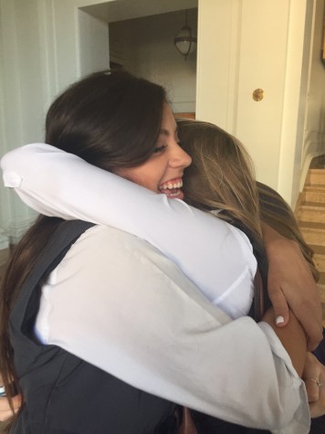Sophomore Agustina Huneeus (left) hugs classmate Jocelyn Shilakes (right) goodbye last Friday in the Main Hall. Friday was Huneeus last day at school before leaving for Barcelona. 