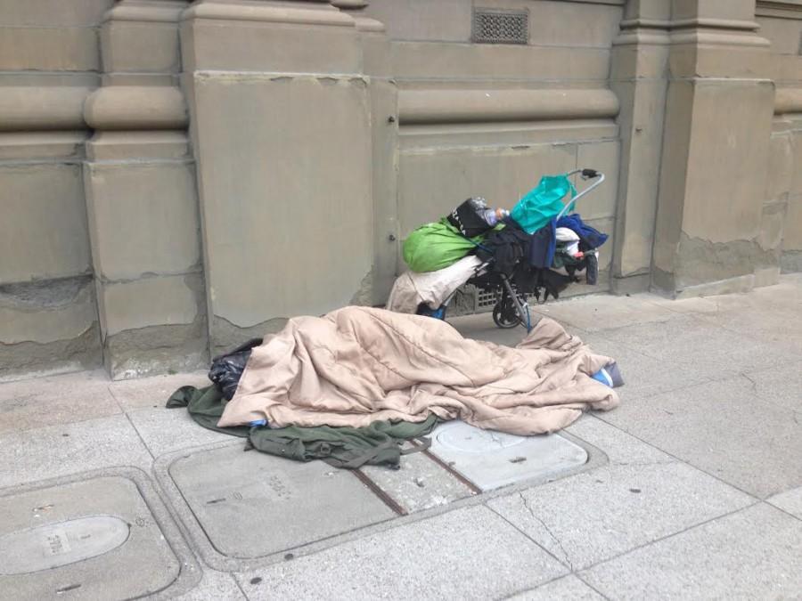 One of San Francisco’s 6,686 known homeless resident sleeps on Webster at California Street, part of the designated walking route between CSH and Stuart Hall HS, on Monday morning. Students are getting involved with helping homeless individuals through volunteer work and on-campus programs.