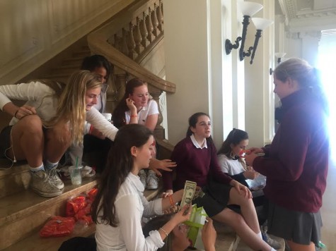 Freshmen Izzy Gutierrez, Grace Boudreau, and Cece Giarman help sell bracelets during the freshman class’s fundraising effort to raise support and money towards tuition for girls in the St. Charles Lwanga Girls Training Center Kalunga in Uganda.