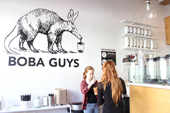 Two girls pick-up their Thai boba tea orders at the 19th and Valencia St. location. The girls waited briefly and watched their drinks being made before getting them.