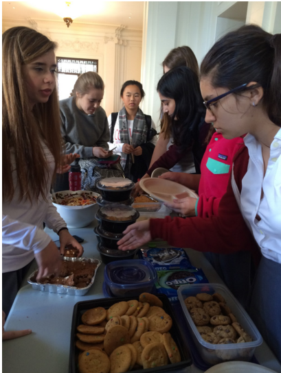 Sophomore Student Council President Carlota Rubio and Secretary Asha Khanna sell potluck dishes during today’s lunch. Student Council organized the event, and sophomores were invited to bring in food. 