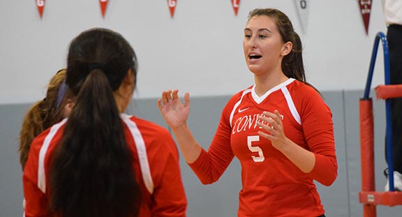 Senior Maris Winslow cheers on her teammates in between plays during a varsity volleyball game. The senior plans to forgo her college sports offers to pursue other interests after a 10-year commitment to the sport.