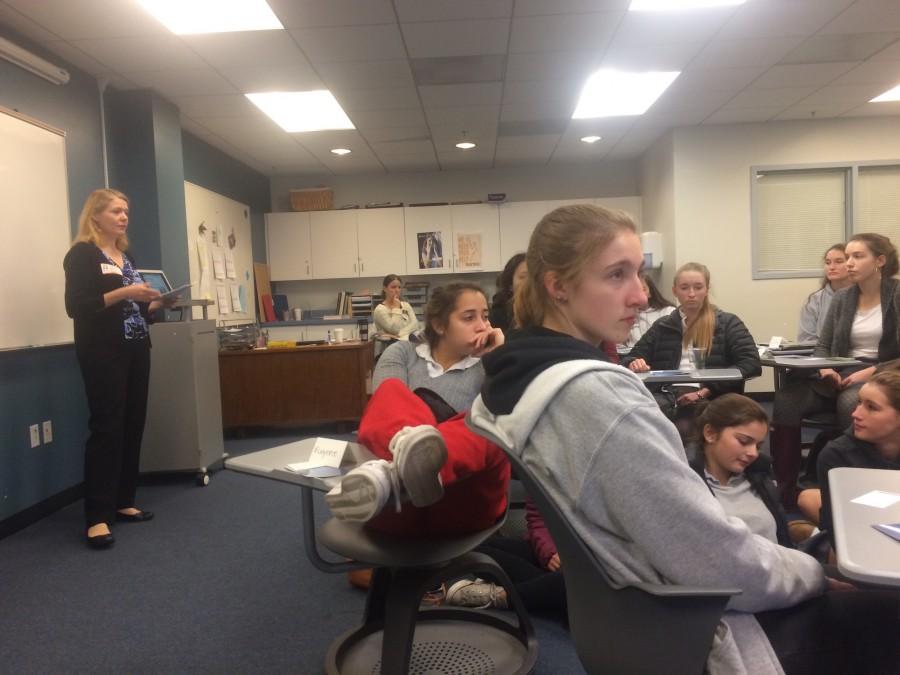 Attendees listen to Dummel as they view her presentation listing stress reduction methods. Juniors and seniors also did breathing exercises and meditation in order to bring the stress reduction process to life. 