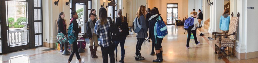 Students mill in the Main Hall before school wearing their heavy backpacks. Bags without waist straps should not weigh more than 10 percent of the wearers weight, but most student packs are considerably heavier.