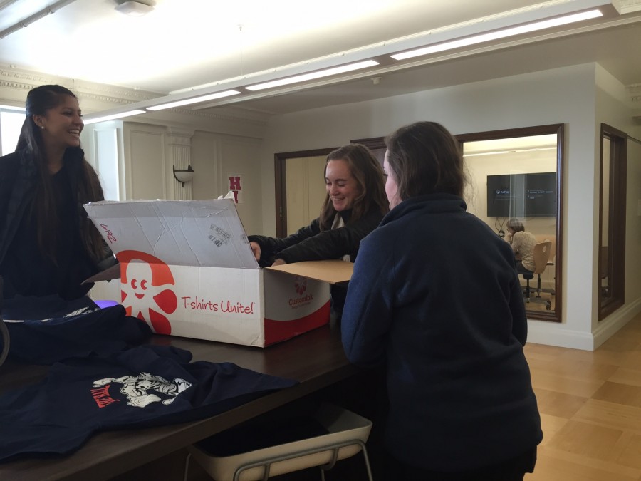 Student Body Publicity Director Victoria Oysterman and Student Body Secretary Nora Hanak sell a shirt to senior Sarah McCarthy. The shirts raise awareness for the upcoming Stuart Hall High School varsity basketball game tomorrow night.
