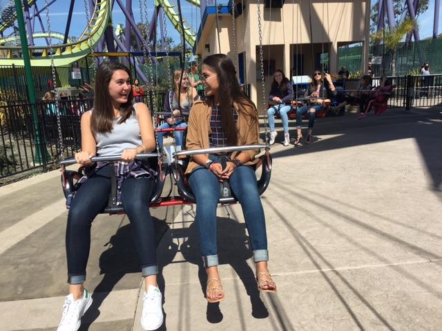 Seniors Alex Farrnán and Victoria Oestermann talk while waiting for a ride to start. Both seniors were part of the announcement of Congé.